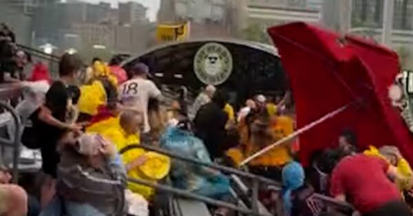 Video shows large umbrella flying through stadium stands